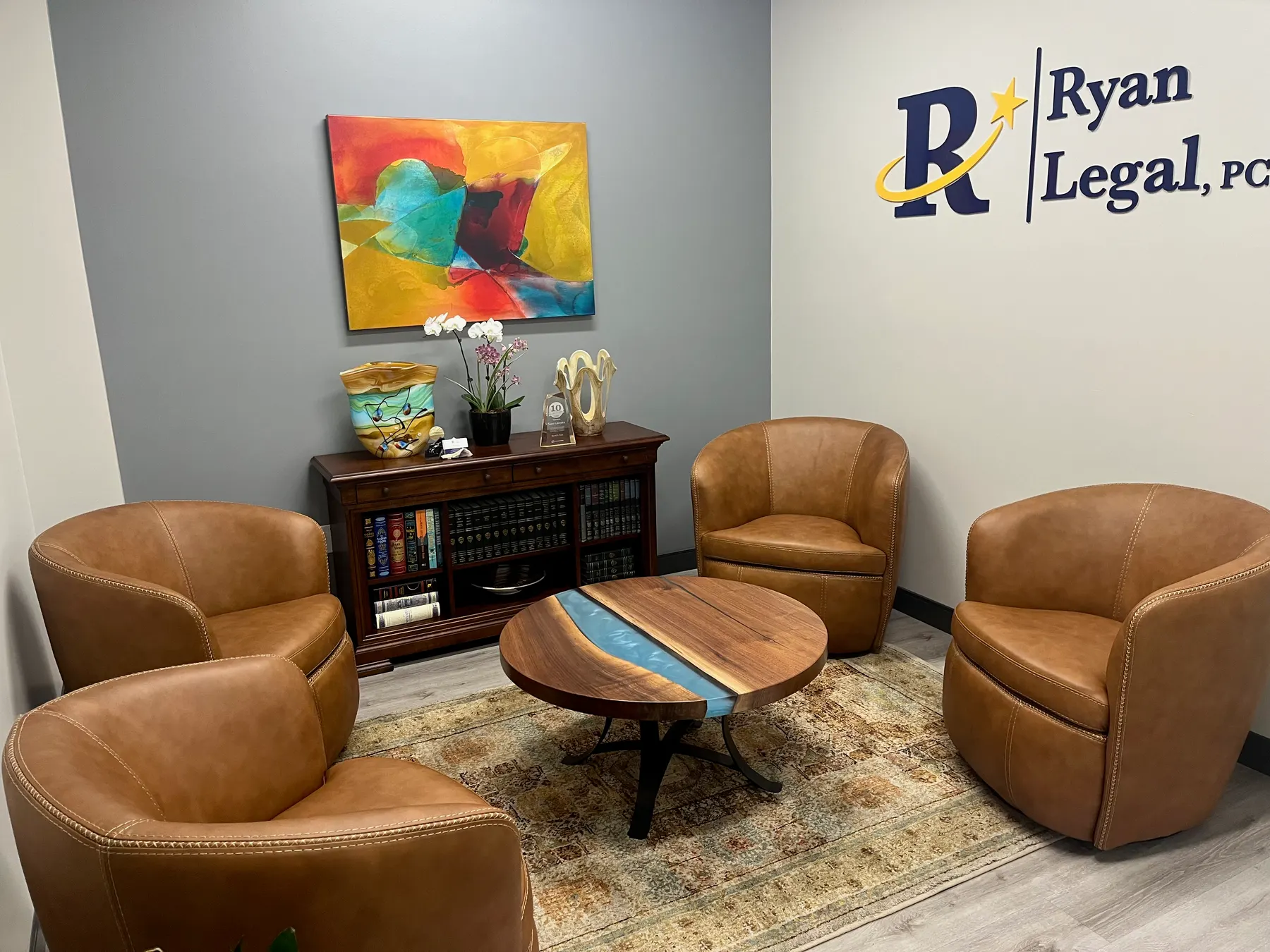 The seating area outside Russ's office at Ryan Legal, PC in Fresno, with the firm's wall sign visible.